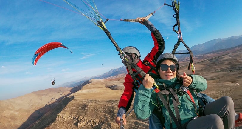 A banner featuring a pilot flying with a woman, both enjoying the flight.