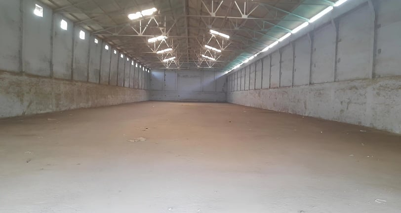 a large warehouse space with a large open space for people to sit and talk and store freight goods