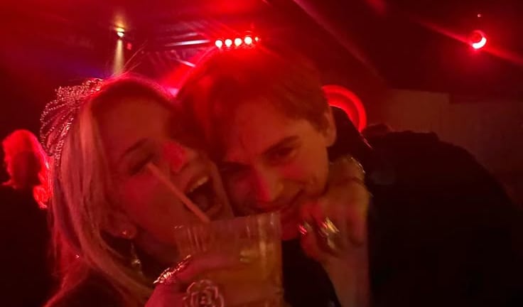 a couple is posing at the bar