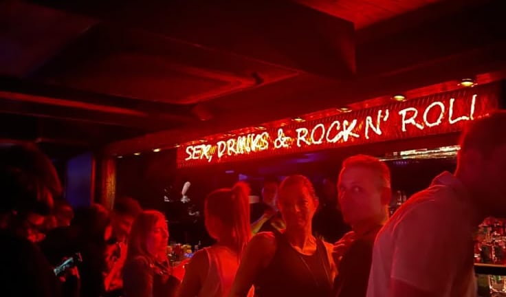 a group of people standing in a bar