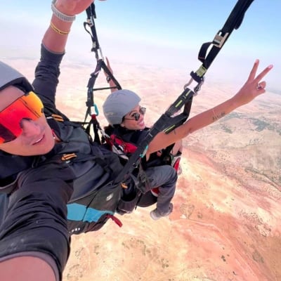 A happy passenger flying in Aguergour, enjoying the scenic view.