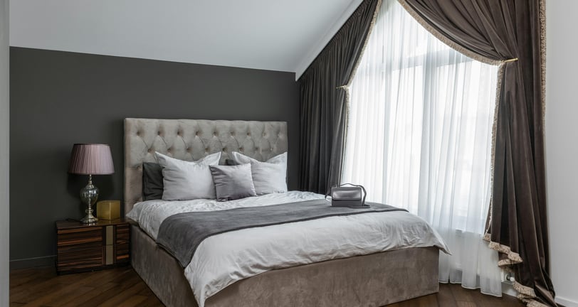 Cozy bed with throw pillows and a soft blanket for comfort.