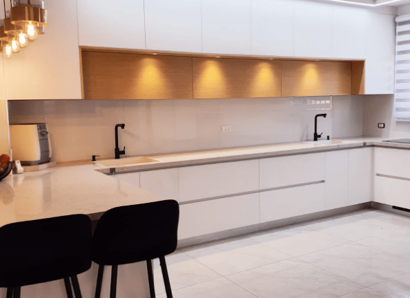 a kitchen with a table and chairs in the middle of the room