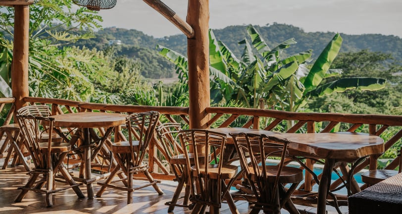 community space overlooking pool and tropical garden