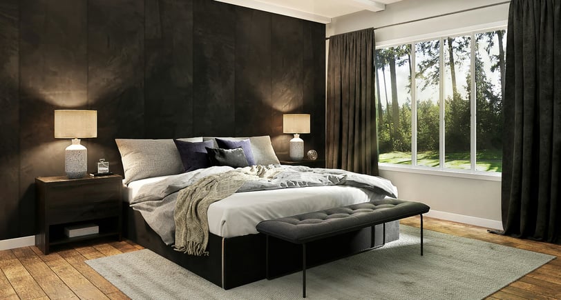 minimalist bedroom with a black color palette and large windows that look out into green trees