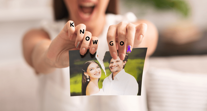 a woman holding up a photo of a man and woman
