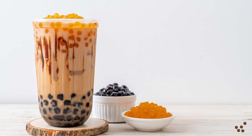 bubble tea with egg pudding, featuring tapioca pearls and creamy pudding chunks in a transparent cup with a straw