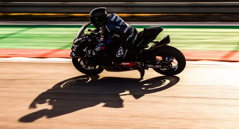 a person riding a motorcycle on a track
