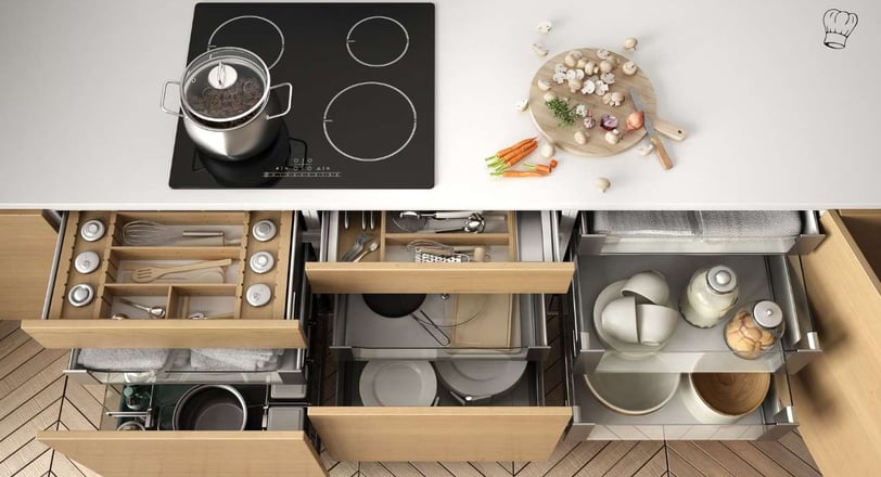 Neatly organized kitchen drawer with dividers for utensils, cutlery, and essential tools