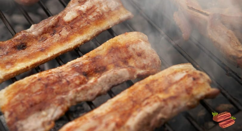 pancetta and bacon grilling on a bbq grill