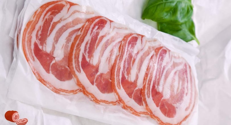 Pancetta slices packed in a lamination bag along with some leafs