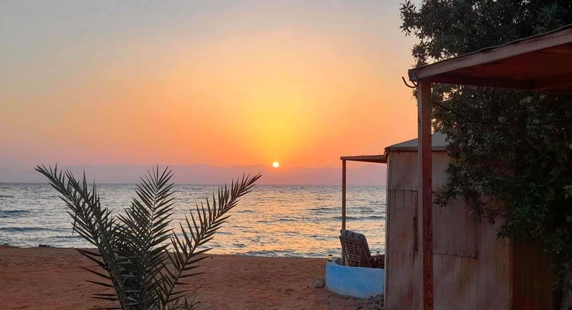 Sunrise and bungalows in front of the sea at Bedouin star Ras shitan Egypt
