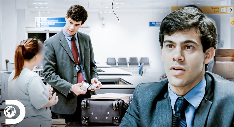 a man in a suit and tie is holding a suitcase