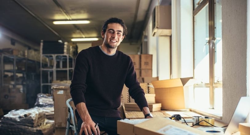 A man standing in a room with boxes of boxes