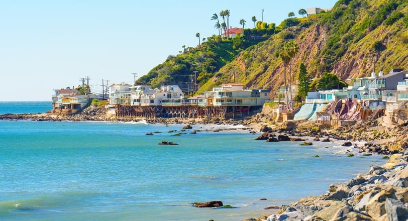 Stunning stilt houses perched at the water's edge on Malibu Beach, California.