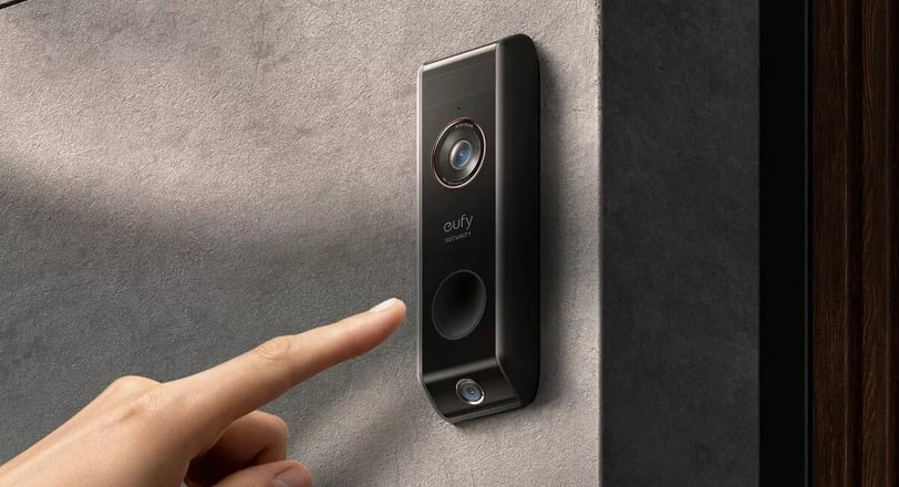 Eufy doorbell on the wall and somone pushing the button