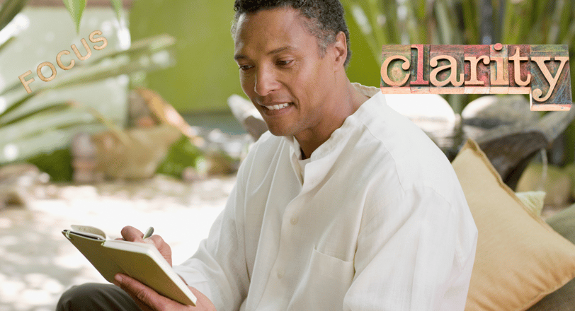 a man in a white shirt is holding a journal