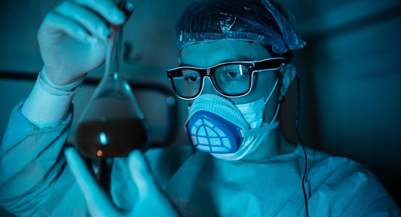 a man in a mask and glasses holding a pipe