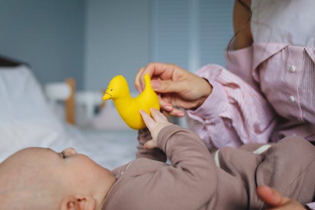 bébé qui joue avec sa maman