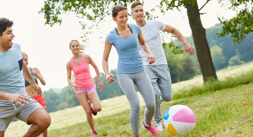 a group of people playing soccer in a field