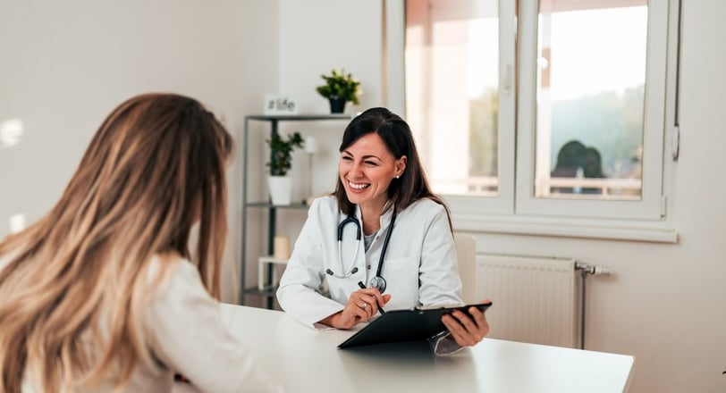 a woman being treated by a doctor in a white coat