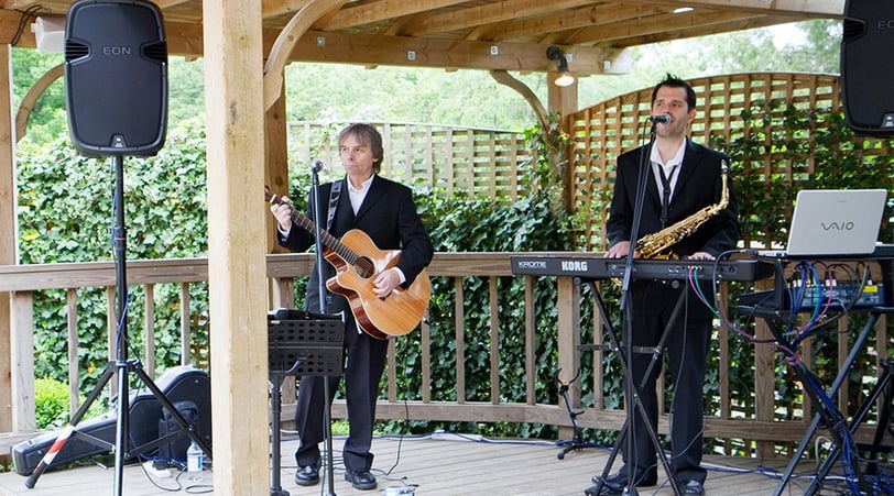 Russ Davey & Anthony Herridge playing music on a deck deck