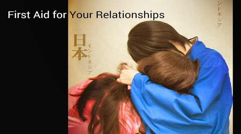 a woman and a man are hugging in front of a wall