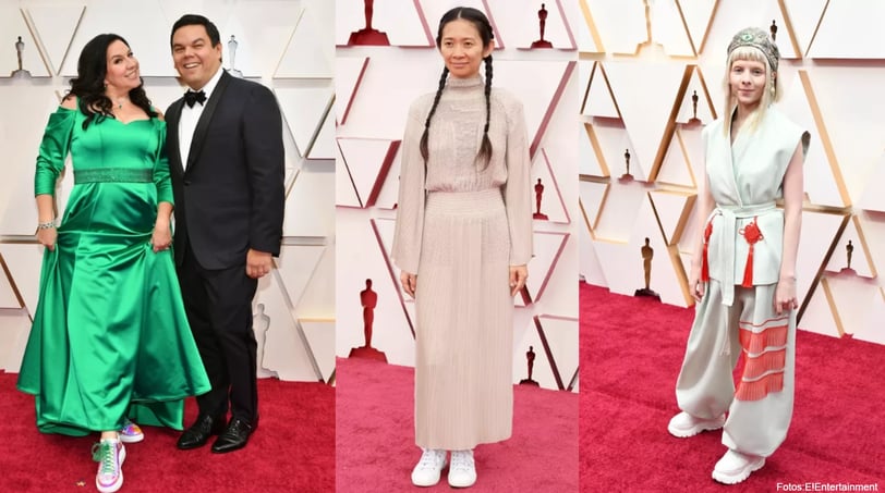 a man and woman in formal wear at the oscar awards