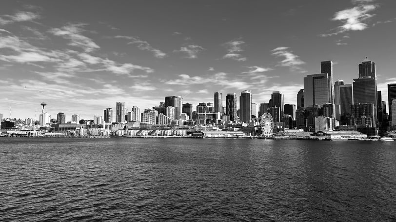 a black and white Seattle city seen from the water