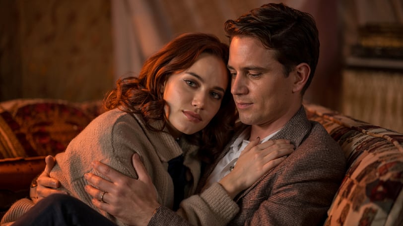 a man and woman sitting on a couch