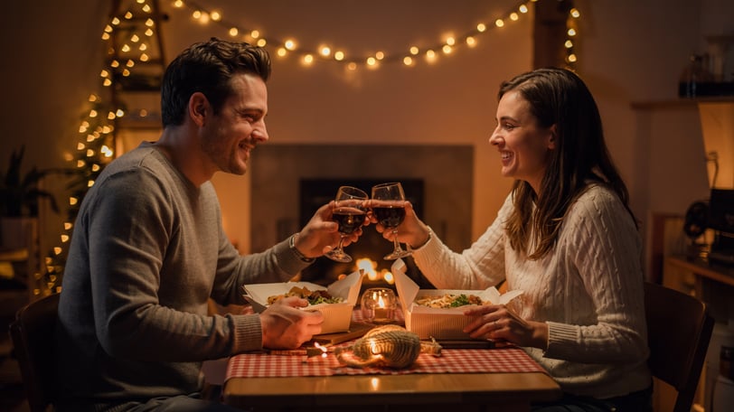 a man and woman sharing a meal at a restaurant