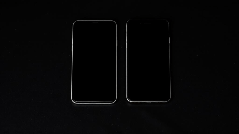 two iphones with a black background and a black background