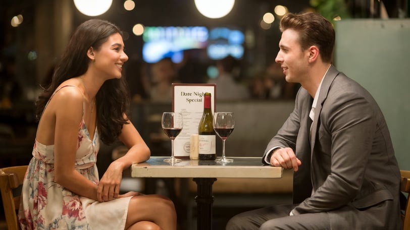 a man and woman sitting at a table
