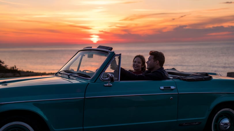 a man and woman in a convertible car