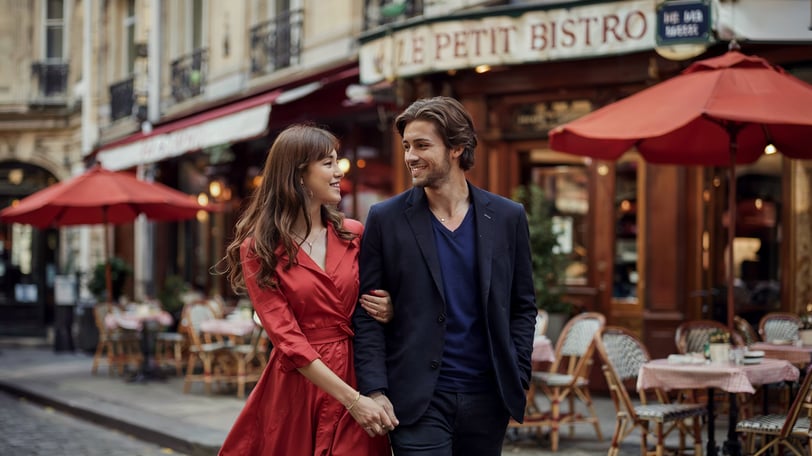 a man and woman walking down a street