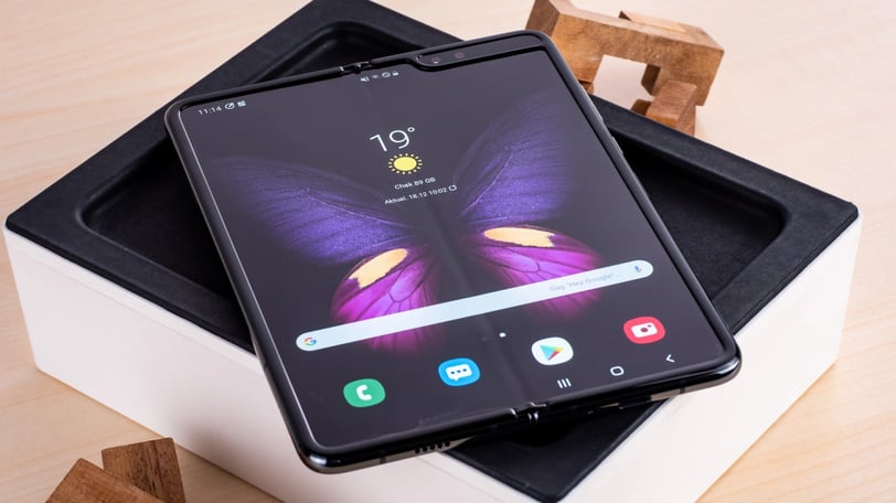 a samsung galaxy note 8 pro with a butterfly on top of it