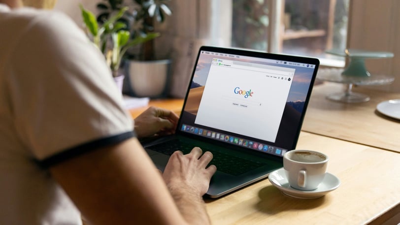 person using google on laptop