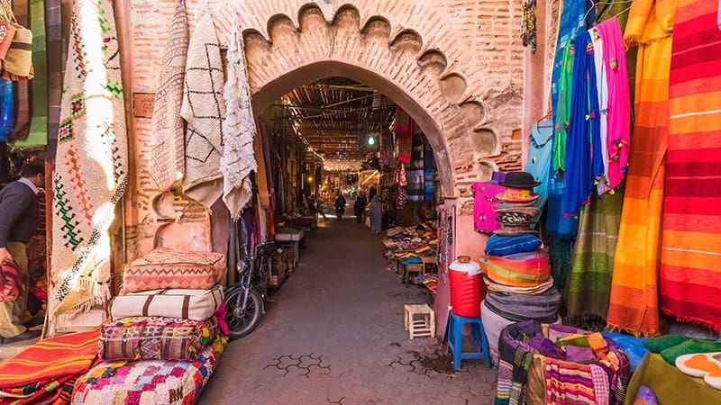 morocco a narrow alleyway with a variety of colorful fabrics and fabrics