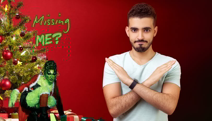 a man with a christmas tree and a woma dressed up as the grinch