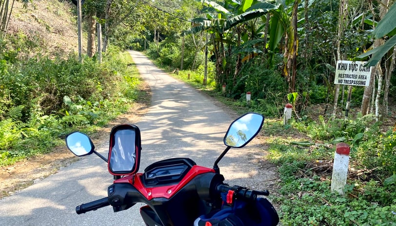 a motorcycle parked on a road with a sign