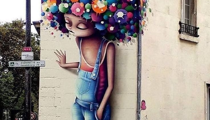 Grafite de um rosto feminino, destacando a diversidade e beleza das pessoas urbanas