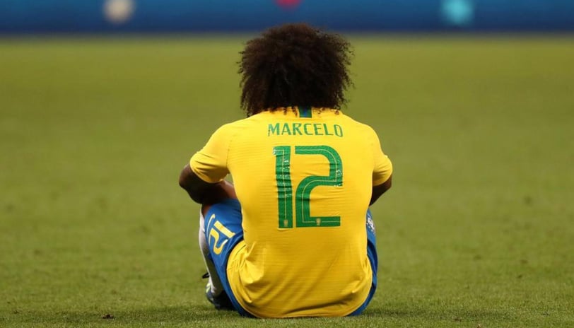 a soccer player sitting on the ground with his foot on the ground