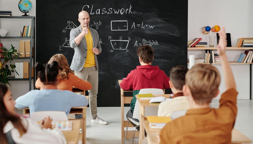 a man standing in front of a chalkboard with a chalkboard