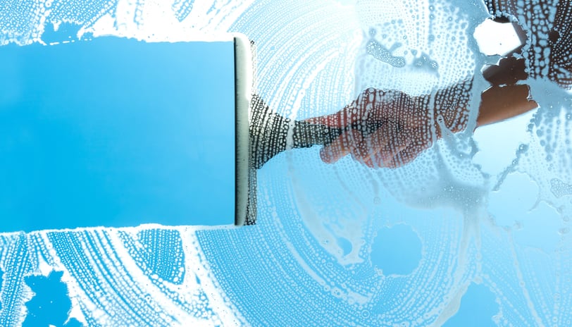 Cleaning a window perfectly with a squeegee in London Ontario and Sarnia Ontario