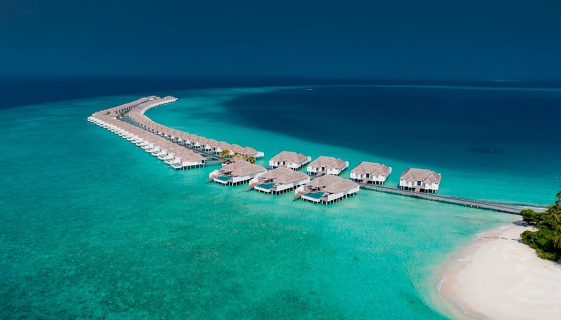 Villas located above sea water near boardwalk in Baa Atoll, Maldives