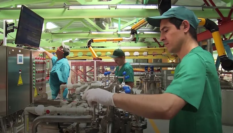 a man in a green shirt and white gloves