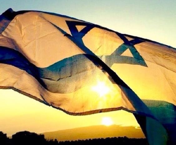 The flag of Israel waving under the sun
