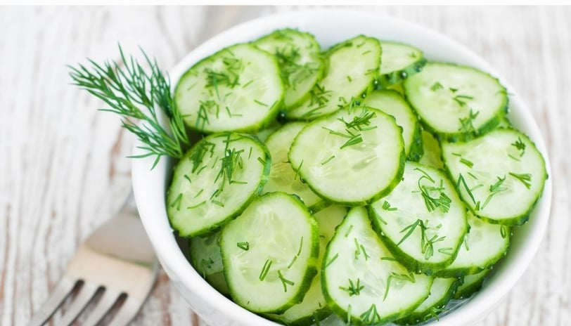 a cucumber salad on a bowl