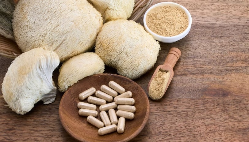 a bowl of mushrooms and pills on a table