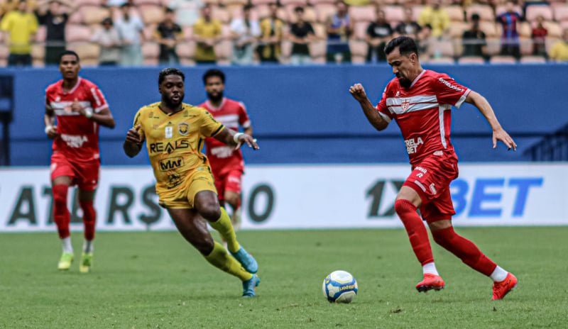 a soccer player is running with the ball